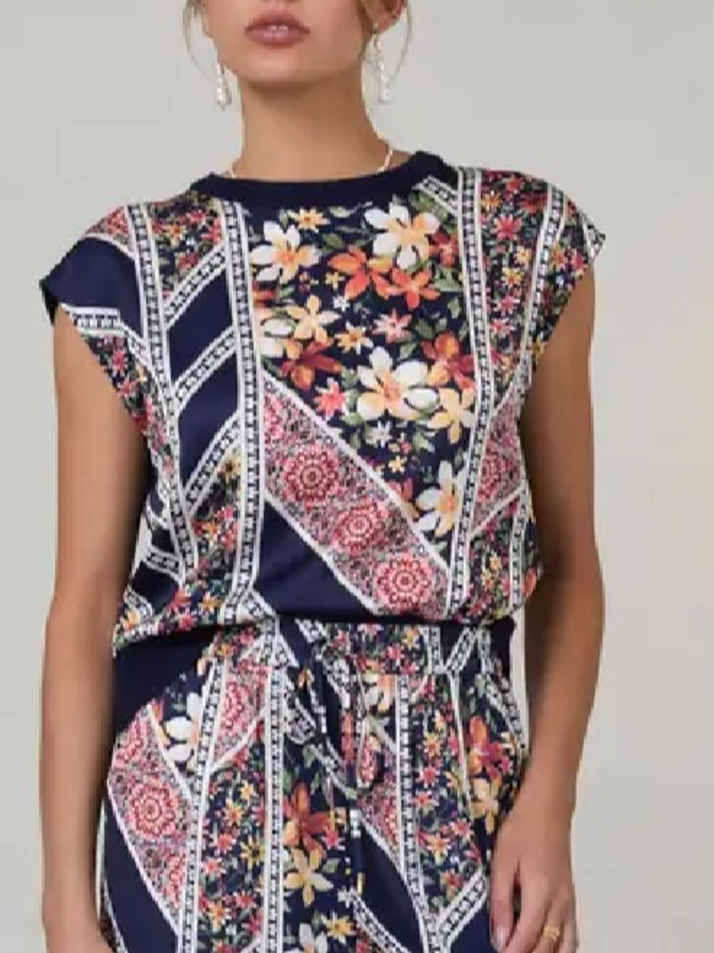 New w Tags. Skies are blue patterned sleeveless top.